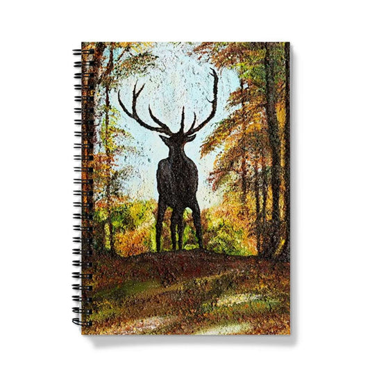 Artistic Journal notebook Proud Stag has the stag in silhouette on the cusp of a hill  against his natural habitat of a forest, blue sky behind his head and antlers