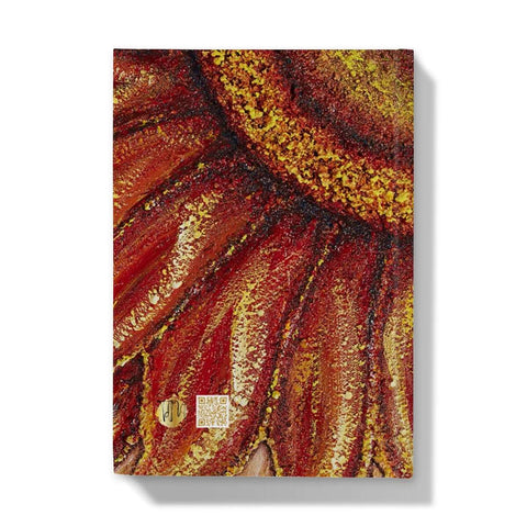 Artistic Hardback Journal Sunflower Passion with the centre of the flower in one corner and the petals reaching out towards the edges of the journal.  Beautiful rich colours of reds & golds