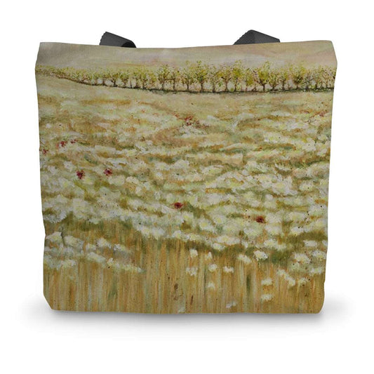 Artistic Durable Tote Bag Shades of a wild field has a  beautiful scene of wild filelds of white & beige, golden wheat with the odd red poppy amongst the white flowers; trees in the distance.