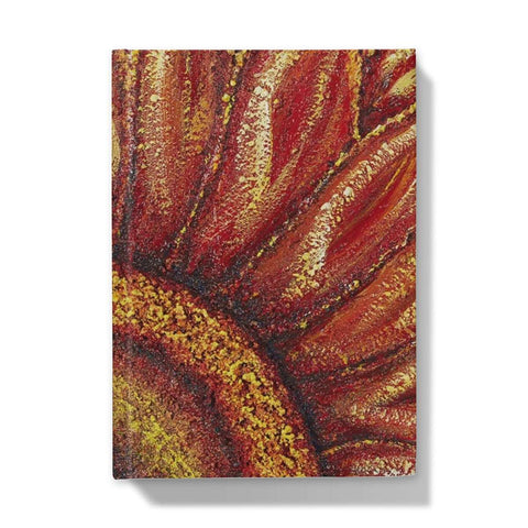 Artistic Hardback Journal Sunflower Passion with the centre of the flower in one corner and the petals reaching out towards the edges of the journal.  Beautiful rich colours of reds & golds