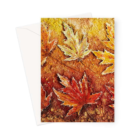 Artistic Blank Greeting Card Autumn Leaves shows a picture of real maple leaves paiinted in golds and Reddy browns, and a very light green also