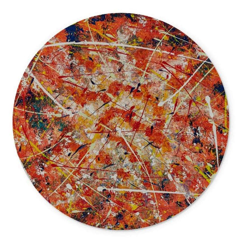 A round beautifully designed Artistic glass cutting board, with abstract design in vibrant oranges, blues, yellows white & golds.