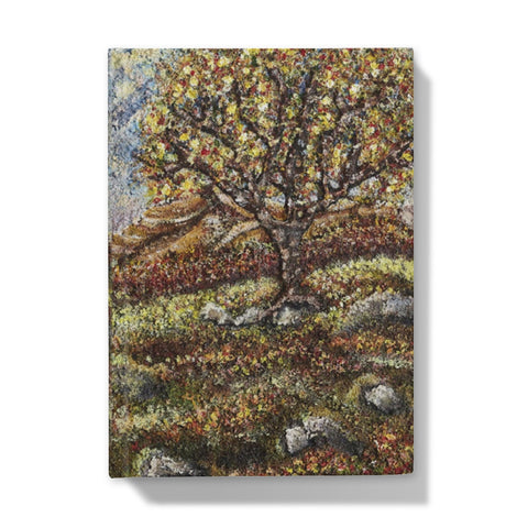 Friendship Tree Hardback Journal  with a beautiful colourful scene of a colourfl tree on an English moorland with hills in the background and rocks closer up with moss and leaves on the floor.