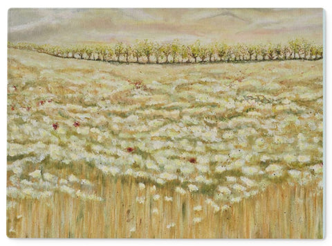 Artistic Glass Cutting Board Shades of a wild field has all the soft colours of beige & creamy white flower dancing in the field with the odd red poppy, trees in the background & a calm sky.