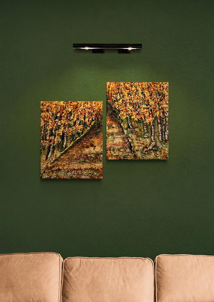 Canvas Print Wall Art.  A two piece of art of a pathway with trees from a forest either side of the path. This piece has an old style look with colours that marry together beautifully.  burnt reds & greens, golds, oranges, but none of these colours are vibrant. They are all washed in a golds . This two piece can be hung on the wall to make the pathway seem longer, and turn in the distance.  Paintings mounted onto a dark green wall with wall light above