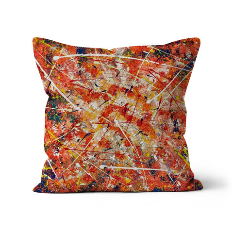 throw pillow with abstract design of splashes of colours in oranges, blues, yellows, whites 