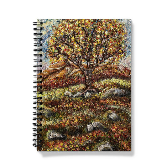 Friendship Tree Notebook, with lots of colours on the leaves of the tree and also on the floor of the moor.  Blue sky and moss & rocks here & there on the ground.  An English tree on the moor in summer