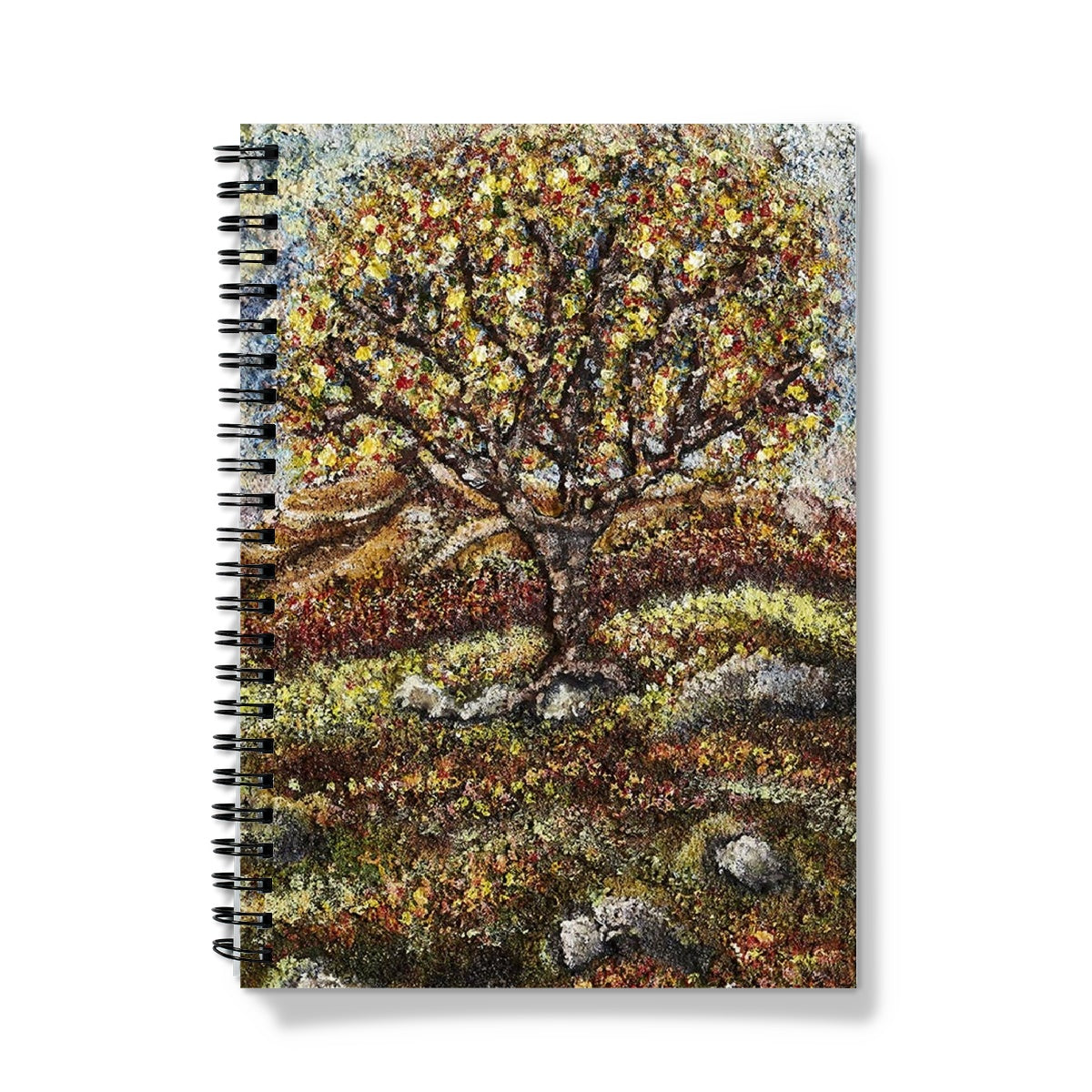 Friendship Tree Notebook, with lots of colours on the leaves of the tree and also on the floor of the moor.  Blue sky and moss & rocks here & there on the ground.  An English tree on the moor in summer