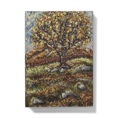 Friendship Tree Hardback Journal  with a beautiful colourful scene of a colourfl tree on an English moorland with hills in the background and rocks closer up with moss and leaves on the floor.