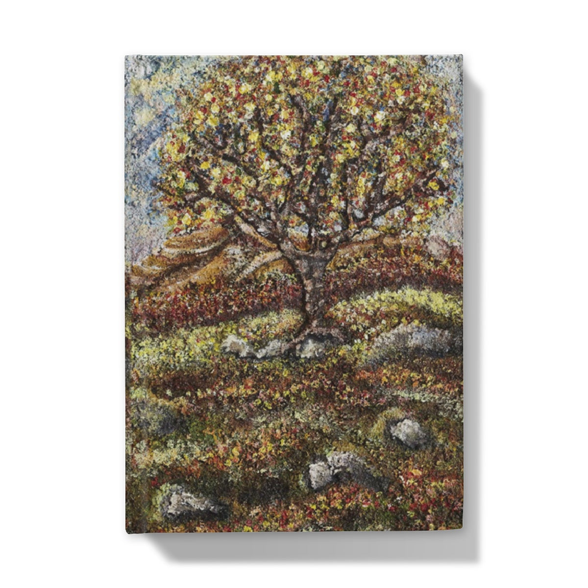 Friendship Tree Hardback Journal  with a beautiful colourful scene of a colourfl tree on an English moorland with hills in the background and rocks closer up with moss and leaves on the floor.