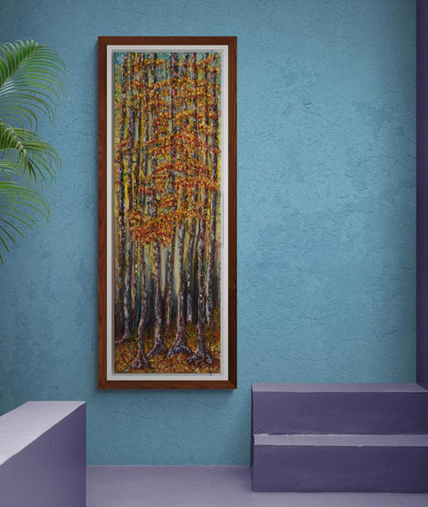 Wall Art canvas 120 x 40 cm of a forest scene deep within the forest. Very tall trees with strong trunks painted with hues of mauve's and blues in the light behind them also, leading to lighter shades as the light changes towards the sky, of pale blue & hints of clouds. The leave are a mix of autumnal colours, golds, reds and bronzes, as is the floor of the forest, where the floor is carpeted with fallen leaves of autumn