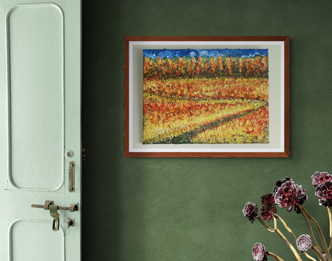 A 30 x 40 canvas Print wall art depicting a meandering pathway through a summer field of grasses and coloured grasses with hints of colour .  This is a contemporain piece so the image is suggestive of all these elements.  In the far distance is a forest of trees in the fall so a mix of autumnal colours reaching up to a blue sky and clouds.  This was inspired after a beautiful day spent with my son in Canada Picture is framed and hung on a sage green wall