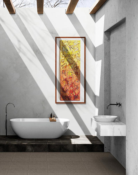 Canvas print wall art tumbling leaves of autumn.A long paining of tumbling maple leaves, staring at the top with light hints of green & yellos through to stronger yellows & golds to auburns to oranges, burnt oranges & reds through to stronger reds & mauve's, hung on a white stone wall in a bathroom