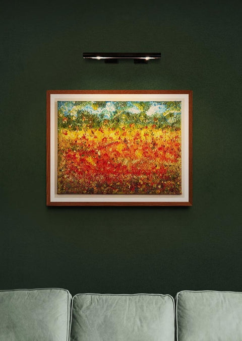 Original Textured canvas wall art summer fields 50 x 40 cm contemporary canvas print wall art of a summer field with reds hinting at poppies mixed with whites & yellows & golds throughout the field. In the distance greens to suggest tall trees, or maybe a forest with the sky above and clouds.  Picture is framed and on a dark green wall with picture light