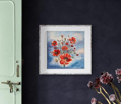 Wall Art Canvas Print Bouquet of Poppies 40 x 40 cm of a bouquet of red poppies with a slate blue & pink colour background. The bouquet is not tightly packed together & allows the poppies to move freely giving the appearance of a natural form of poppies in a field. Picture is framed in silver & hung on a dark blue wall