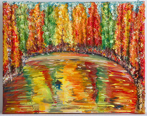 Wall Art Canvas Print Reflections A very colourful piece of art of Canadian trees around a lake reflecting the colours in the water. The texture difference between the trees & water makes this piece stand out. All the colours are autumnal colours found in the fall in Canada: yellows, greens reds, orange. A real feast for the eyes! Picture mounted onto a pale violet colour & framed in wood