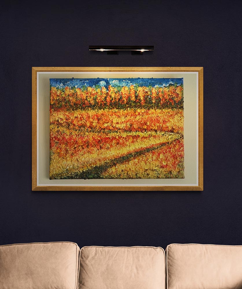 A 30 x 40 canvas Print wall art depicting a meandering pathway through a summer field of grasses and coloured grasses with hints of colour .  This is a contemporain piece so the image is suggestive of all these elements.  In the far distance is a forest of trees in the fall so a mix of autumnal colours reaching up to a blue sky and clouds.  This was inspired after a beautiful day spent with my son in Canada.  Picture is hung on a dark blue wall and framed with a pale wood colour with white inner surround